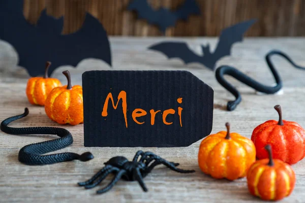Black Label, Text Merci Means Thank You, Scary Halloween Decoration — Stock Photo, Image