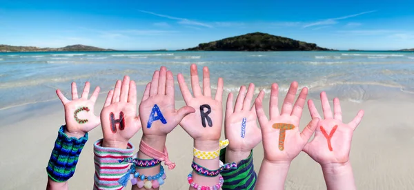 Children Hands Building Word Charity, Ocean Background — Stock Photo, Image