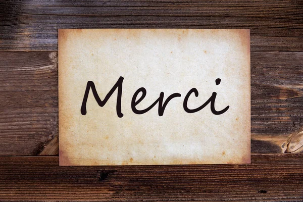 Old Paper, Merci Means Thank You, Wooden Background — Stock Photo, Image