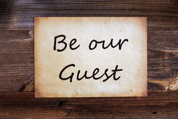 Old Paper, Text Be Our Guest, Wooden Background — 스톡 사진