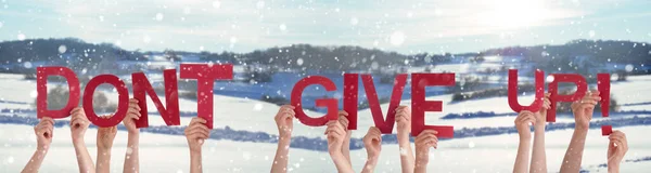 People Hands Holding Word Do not Give Up, Snowy Winter Background — стоковое фото