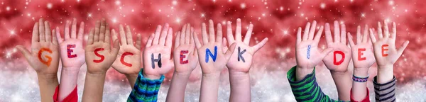 Children Hands Geschenkidee Means Gift Idea, Red Christmas Background — 스톡 사진