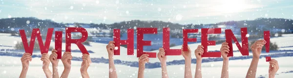 People Hands Holding Word Wir Helfen Means We Help, Snowy Winter Background — Stock Photo, Image