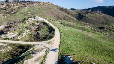 aerial view of car riding by mountain road, Israel clipart