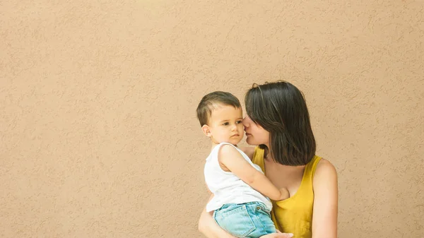 Mãe Tocando Filho Bochecha Rua Perto Parede Bege — Fotografia de Stock