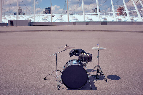 close up view of black drum kit and drum sticks on street