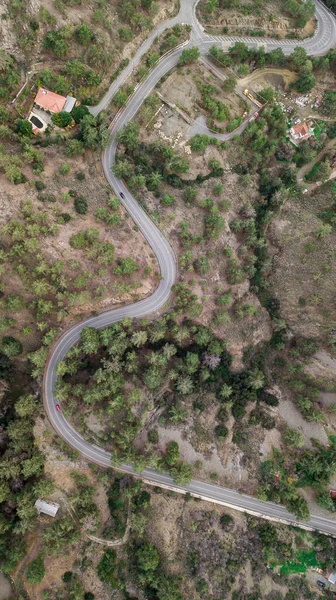 Aerial view of curvy hill road surrounded with trees, Cyprus — Stock Photo