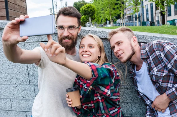 Happy young friends taking selfie with smartphone on street — Stock Photo