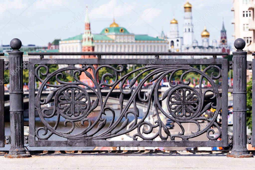 Black cast iron fence of the bridge over the Moscow river in the city center with a view of the Kremlin