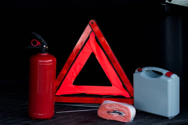 Set of fire extinguisher, first aid kit, emergency stop sign and tow rope