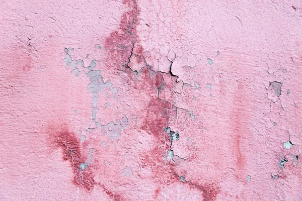 red concrete wall with cracks and falling off paint, texture
