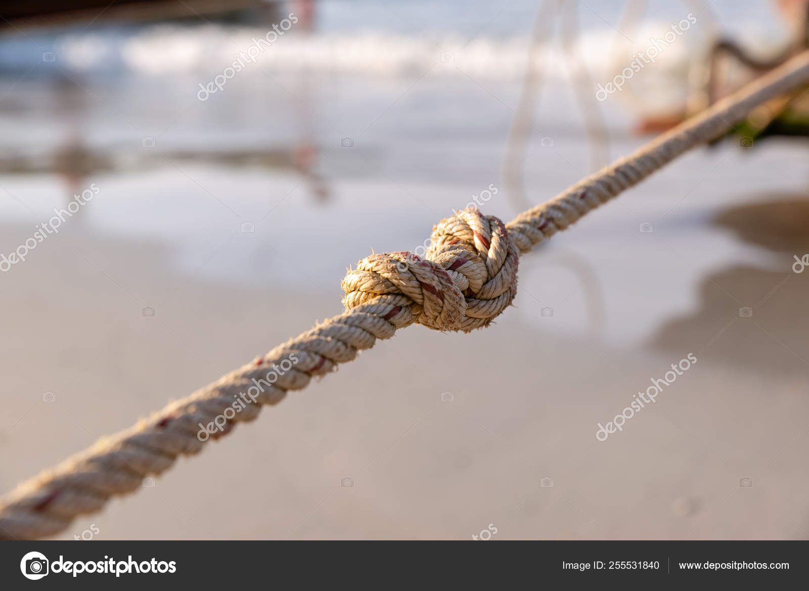 Rope, with a single tight knot, suspended horizontally in the air, against  black background — Stock Photo © Spritnyuk #255531840
