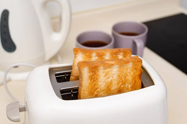 toasted pieces of white bread in a toaster