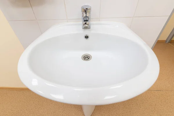 White sink with medical facility shot on wide angle lens