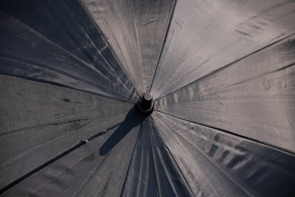 Raindrops falling on black umbrella outdoors. — Stock Photo, Image