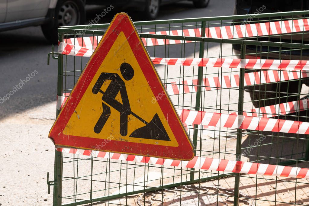 Repair work. Repair of roads on the streets. The construction site of the streets of the city with barricades and a network of safety fences, road works and detour signs. Closed pedestrian crossing.