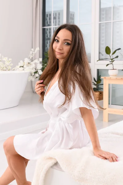 Young Woman Sitting White Silk Robe Edge Bed White Bathroom — Stock Photo, Image