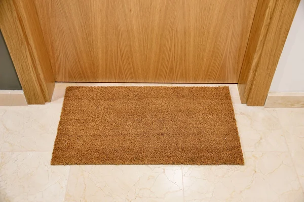 Brown welcome mat at front door