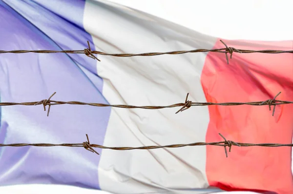 Metal fence with barbed wire on a French flag. Separation concept, borders protection.Social issues on refugees or illegal immigrants