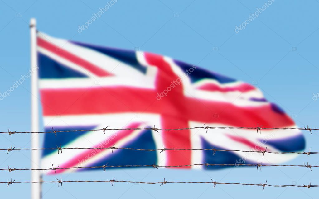 Metal fence with barbed wire on a Britain flag. Separation concept, borders protection.Social issues on refugees or illegal immigrants