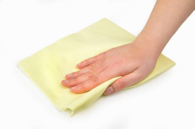 Hand wiping surface with yellow rag isolated on white clipart