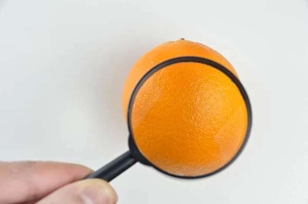 Herziening Van Een Oranje Met Een Vergrootglas — Stockfoto