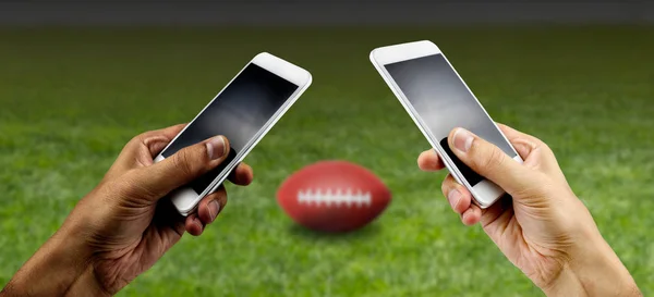 Friends using mobile phone and betting during a football.