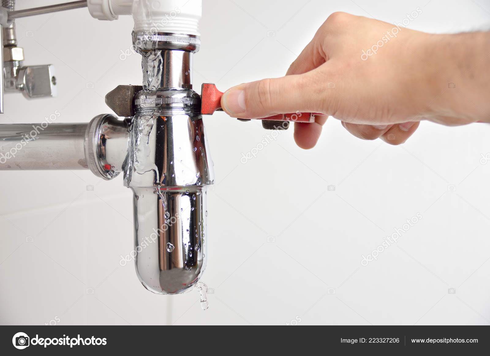 Plumber Fixing Sink Pipe Adjustable Wrench Stock Photo