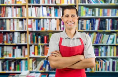 a worker at a bookstore smiling and looking at camera clipart