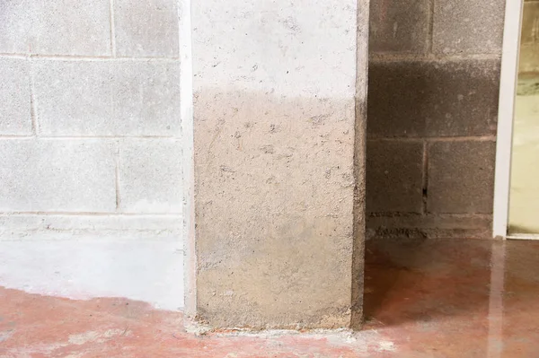 Damage to a concrete column from water in the basement