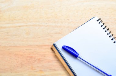 ofis ahşap masa üstünde kalem ile boş bir not defteri