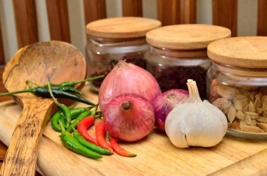 Pişirme malzemeleri. Baharat ve otlar ile soğan ve sarımsak ahşap tahta üzerinde