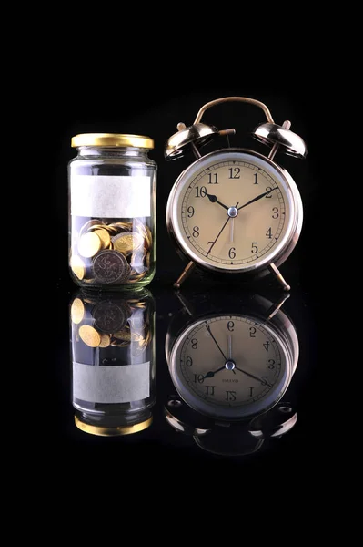 Alarm Clock Bottle Coins Isolated Black Background — Stock Photo, Image