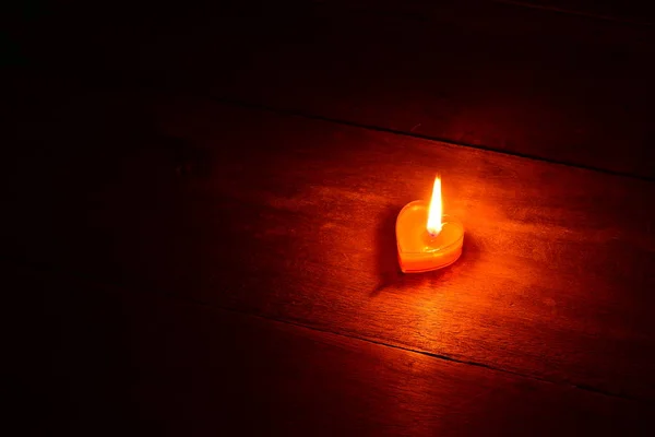 Primer plano del corazón candente de vela roja sobre fondo oscuro — Foto de Stock