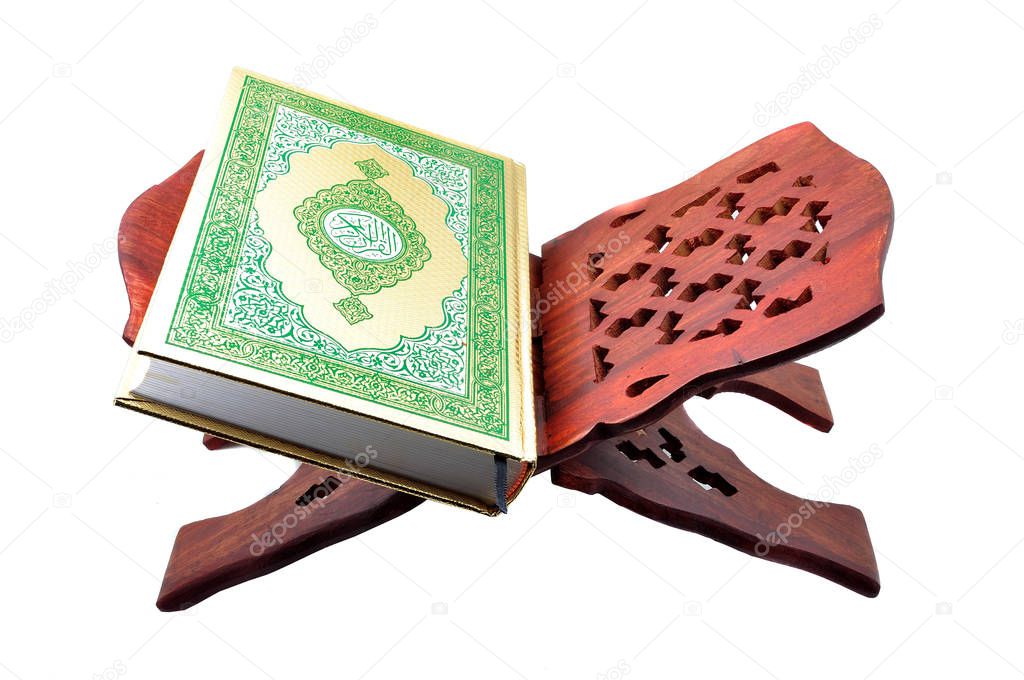 Holy Koran on the book rest. Isolated on the white background.