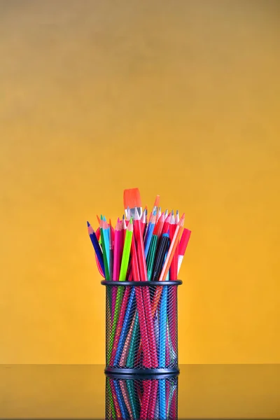 Desk organizer filled with colored pencils