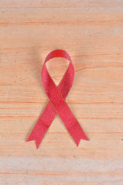 Womens health symbol in ribbon on wooden board