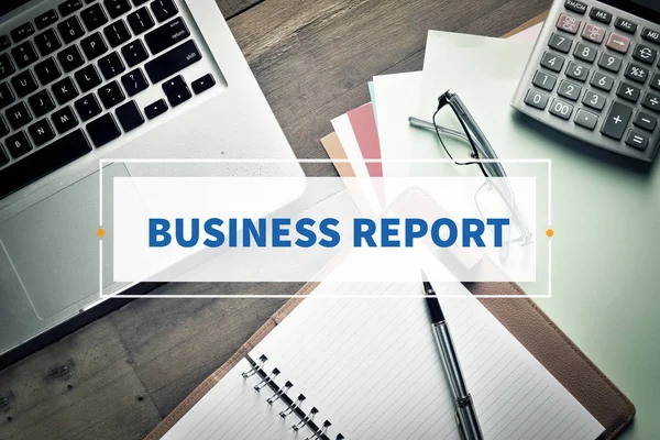 Notebook and Laptop with text BUSINESS REPORT