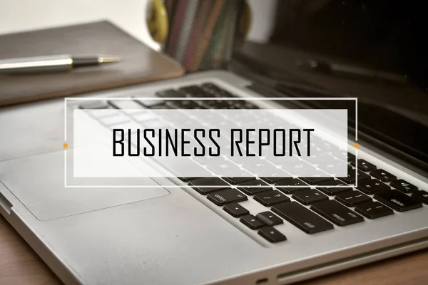 Notebook and Laptop with text BUSINESS REPORT