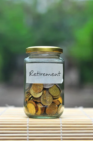 Münzen in Flaschen mit Etikett Ruhestand - Finanzkonzept — Stockfoto