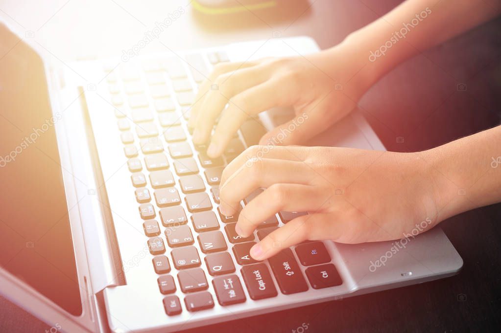 Closeup of businesswoman hands typing on laptop keyboard with mouse