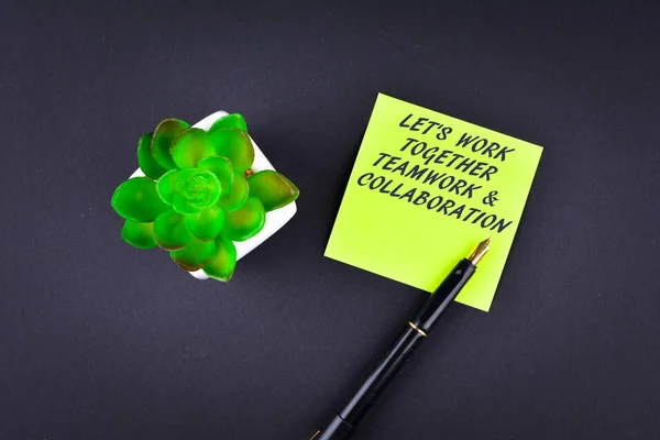 Green sticky note with pen with text Let's work together - Teamw — Stock Photo, Image
