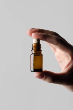 İlaç şişe Mock-Up-gri bir arka plan üzerinde bir ilaç şişesi holding erkek eller