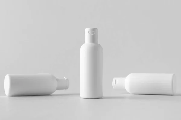 White plastic cosmetic lotion bottle mock-up with cap.