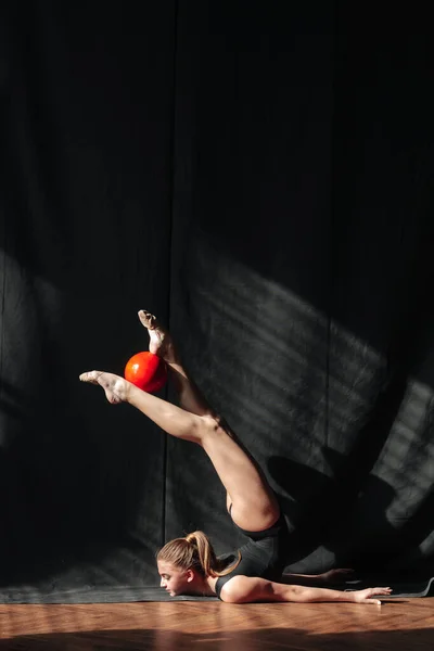 Young gymnast girl stretching and training