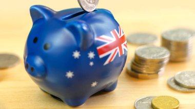 Australian piggy bank and coins savings concept, closeup. clipart