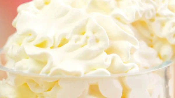 Macro closeup of swirls of whipped cream for cake decorating. — Stock Photo, Image