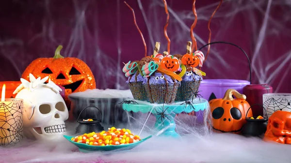 Halloween candyland dropp tårta stil muffins i part dukning. — Stockfoto