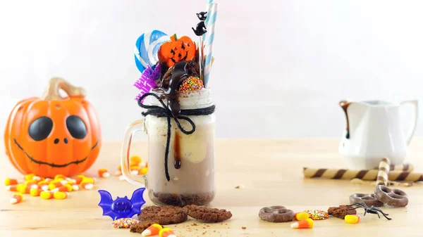 On-trend Halloween freak shakes decorated with candy, cookies and lollipops. — Stock Photo, Image