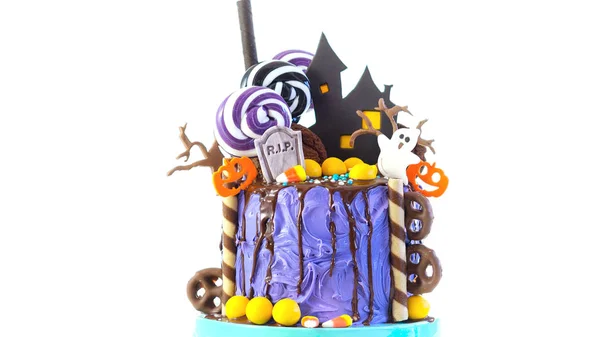 On trend Halloween candyland novelty drip cake on white background. — Stock Photo, Image